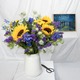 bouquet composé de  de lisianthus bleus de delphiniums bleus de nigelles bleues de  santinis jaunes de  tournesols jaunes de feuillages de saison