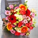 Ramo Otoño con germinis rojas y naranjas, lisianthus rosa y claveles en tonos claros y coral